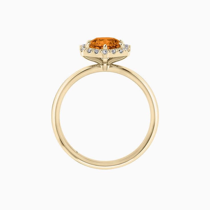 Round Brilliant cut Orange Sapphire with a hexagon shape halo