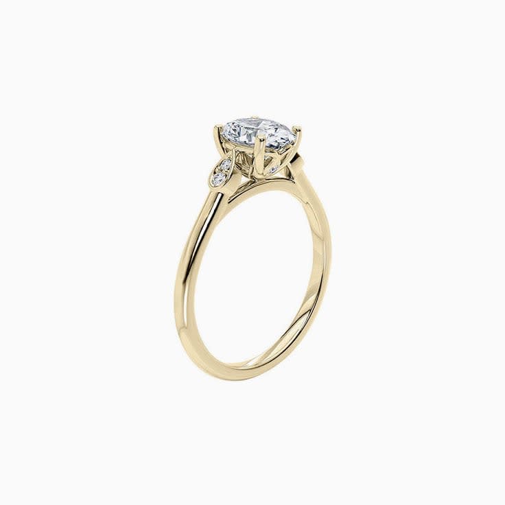 Oval Diamond ring with bezel set side stones