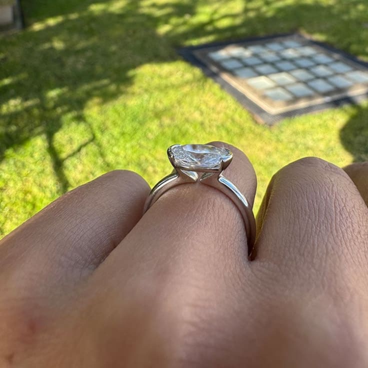 Partial bezel oval engagement ring
