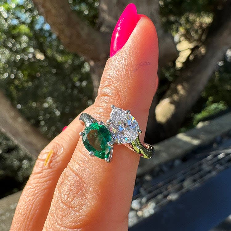 Green emerald and pear diamond ring