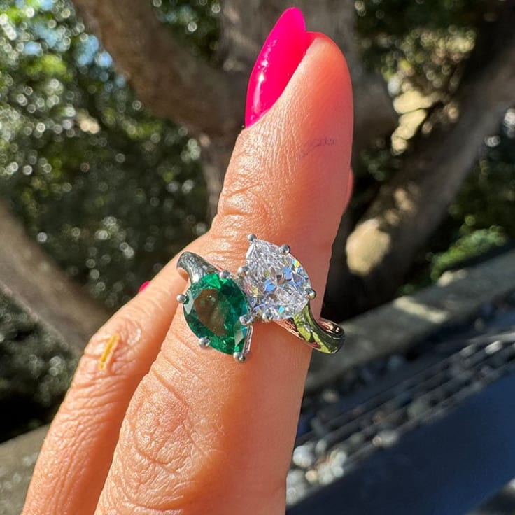 Green emerald and pear diamond ring