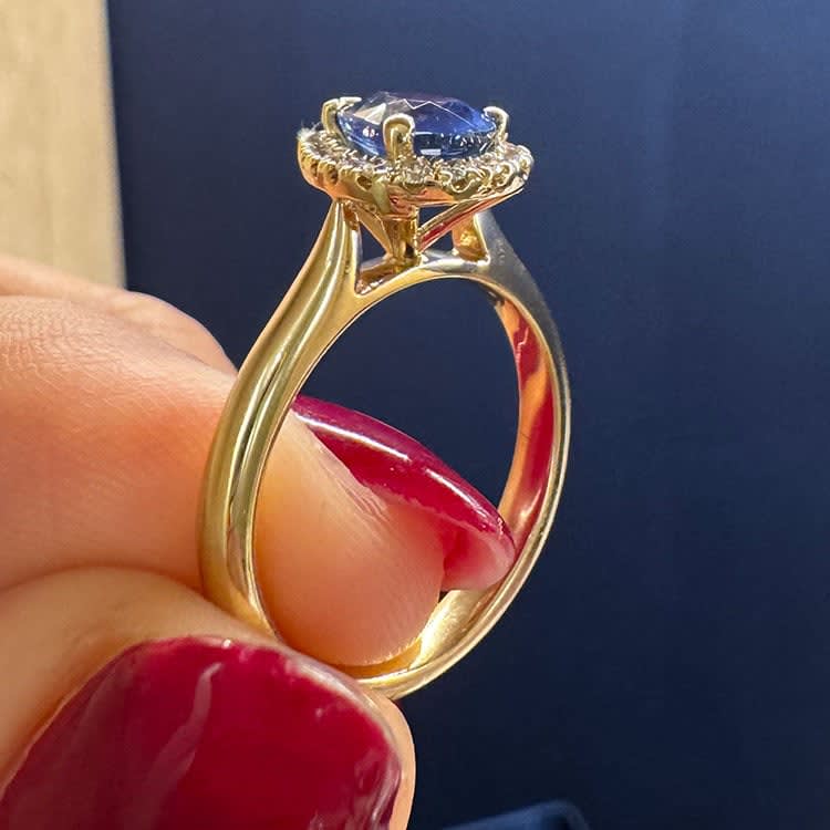 Natural blue sapphire with halo and plain band