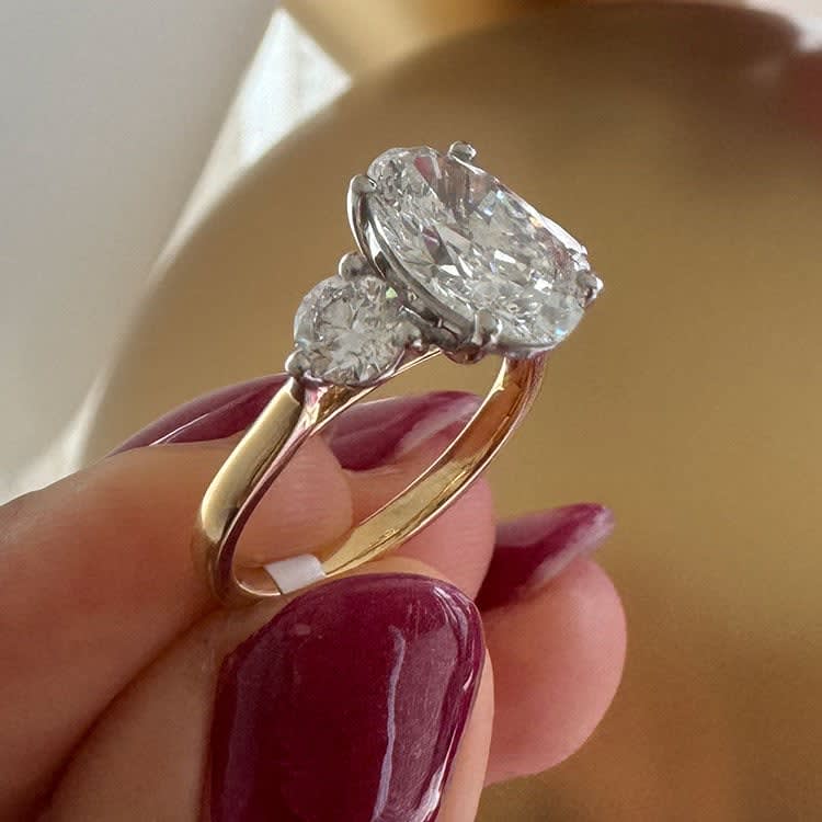 Oval with round diamond trilogy