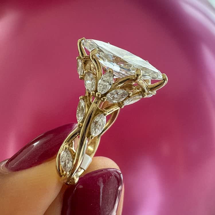 Marquise cut engagement ring with detail band