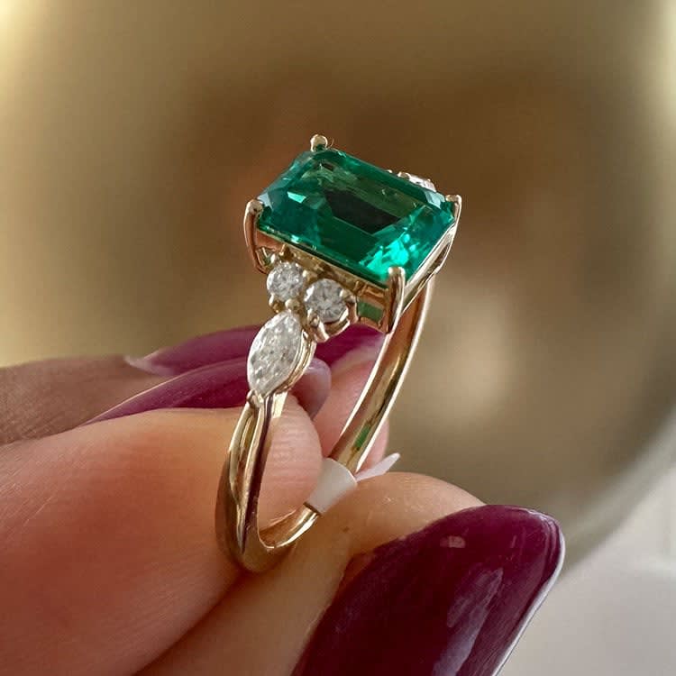 Lab emerald and diamond ring set in gold