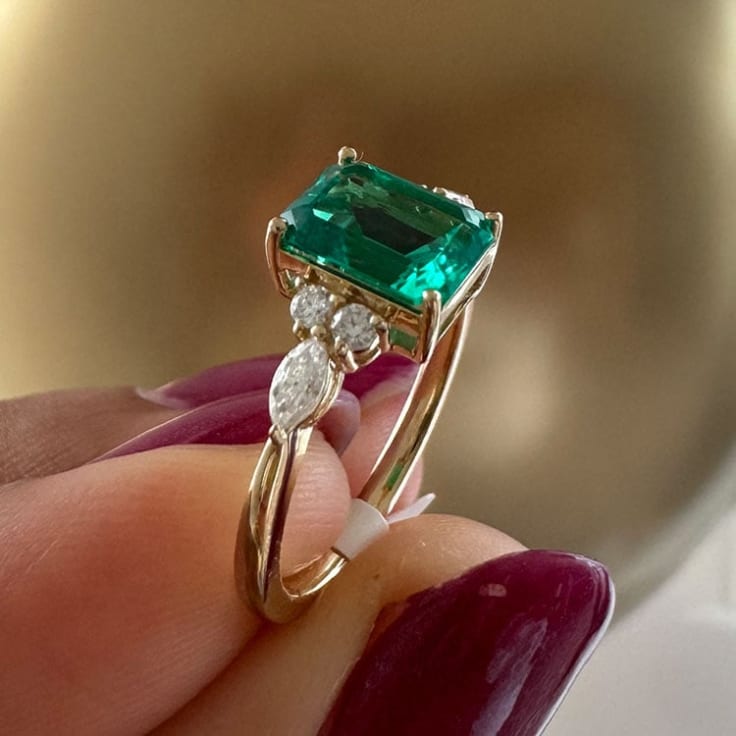 Lab emerald and diamond ring set in gold