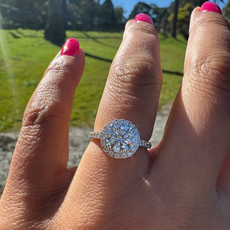 Round diamond with a halo classic engagement ring