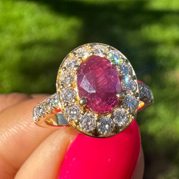 Natural ruby with halo on a gold band