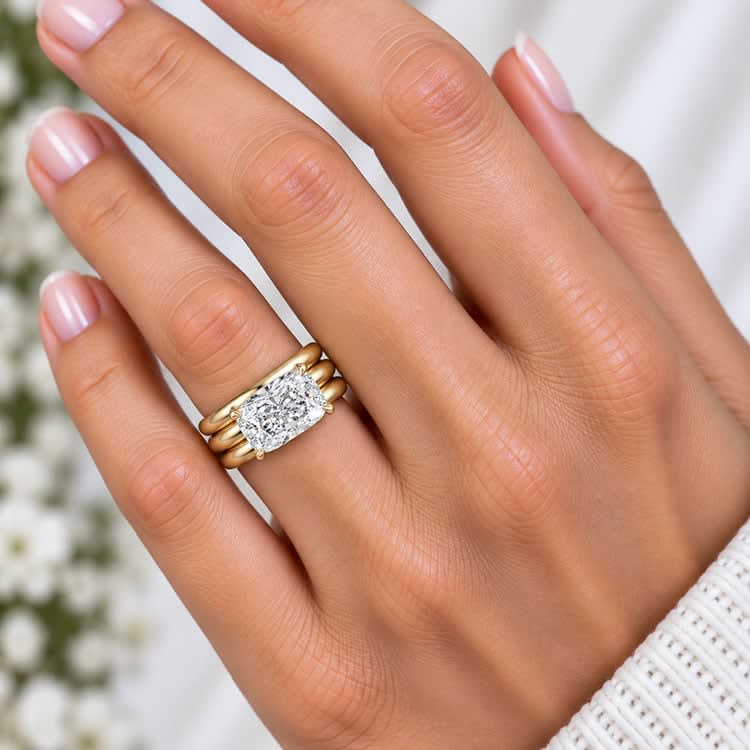 elongated cushion set on a solid wide gold band