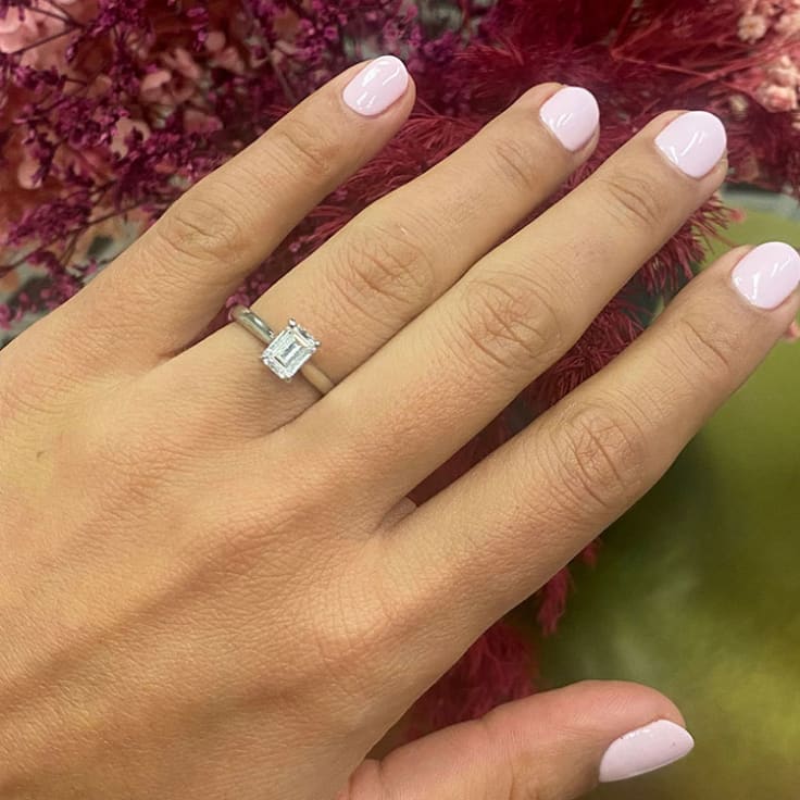 Emerald solitaire Engagement ring on a plain band