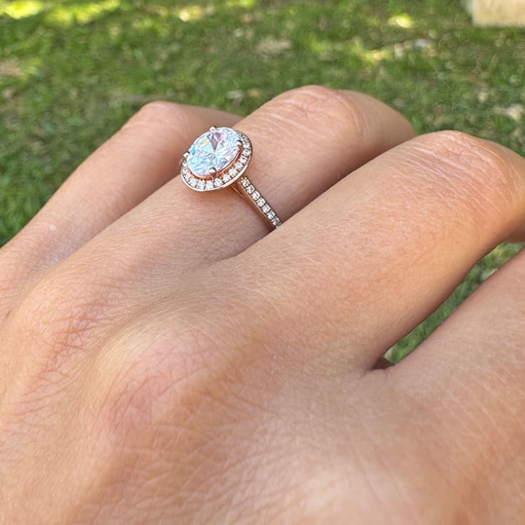 Oval Cut engagement ring with a diamond halo and diamond band