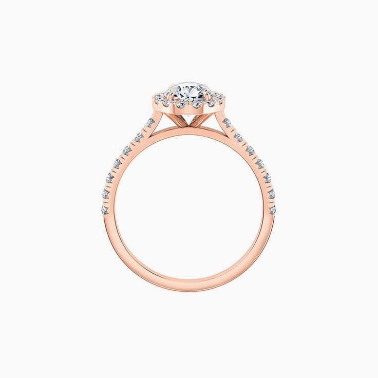 Pear cut diamond engagement ring with halo and diamond band