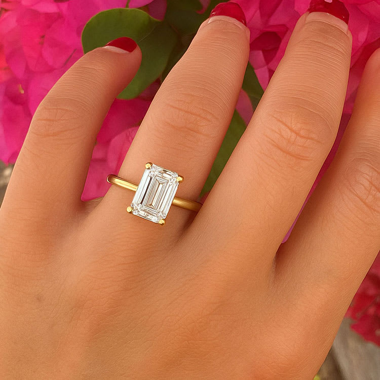 Emerald engagement ring on a plain band